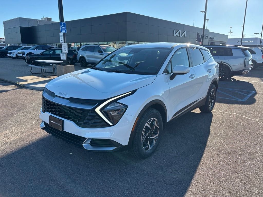 2023 Kia Sportage LX in Snow White Pearl — front three-quarter view